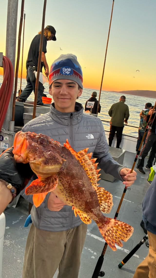 Angler shows off a colorful rockfish at sunset