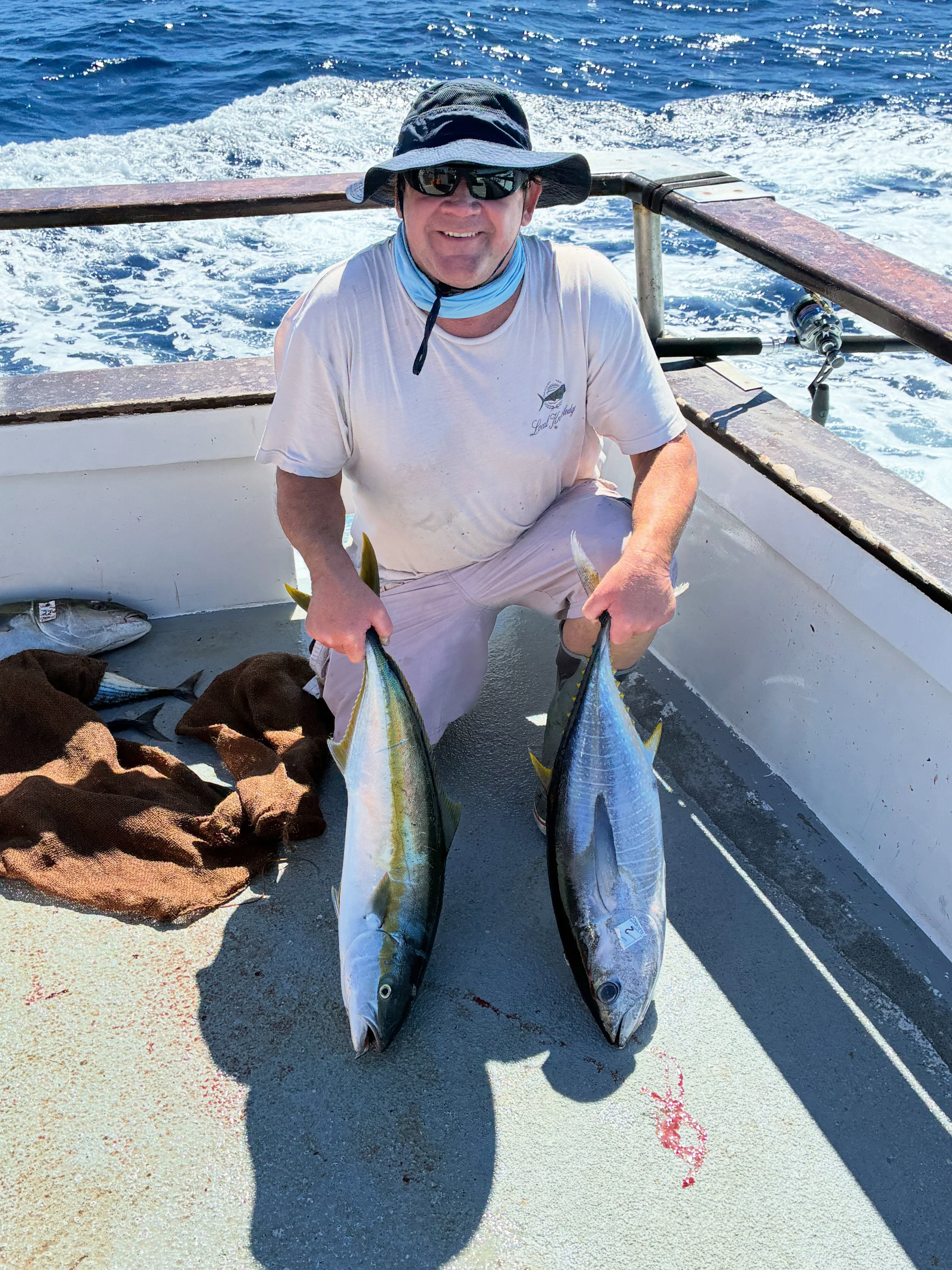 Angler poses with yellowtail and tuna catch