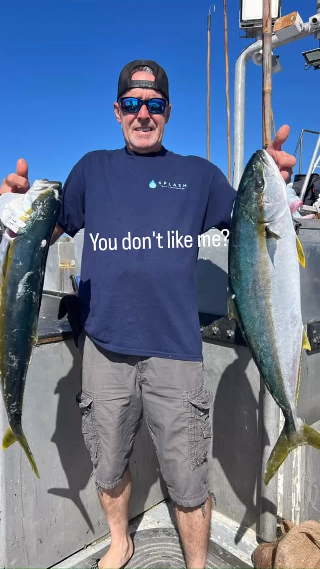 Angler poses with a pair of yellowtail on a slower day