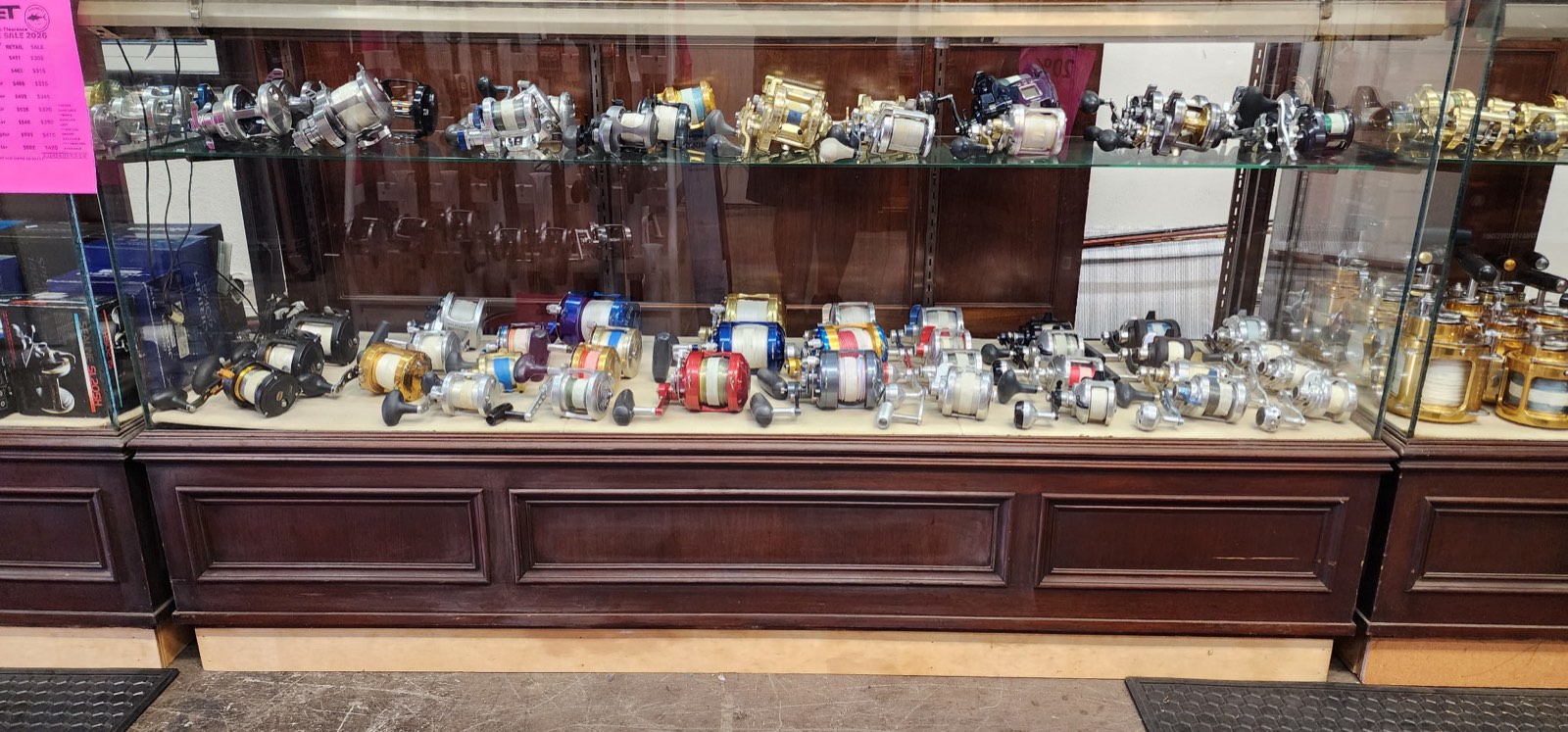 Glass counter stacked with used saltwater reels