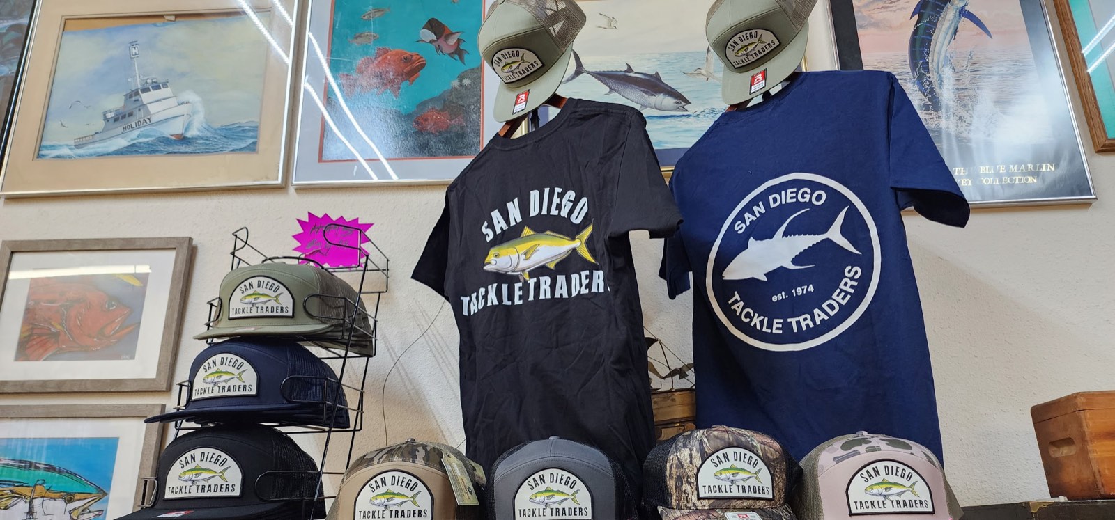 San Diego Tackle Traders logo t-shirts and hats on display