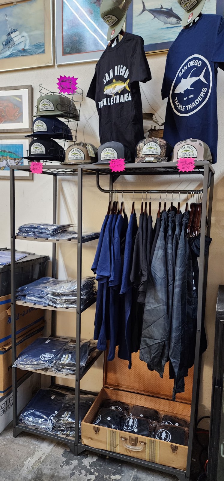 Apparel rack with San Diego Tackle Traders tees and hats